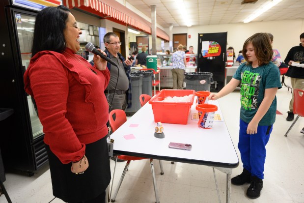 Fegely Middle School Principal Ann Marie Caballero laughs as a student votes for her grandmother's arroz con pollo to become a permanent lunch choice on Wednesday, Jan. 29, 2025. (Kyle Telechan/for the Post-Tribune)