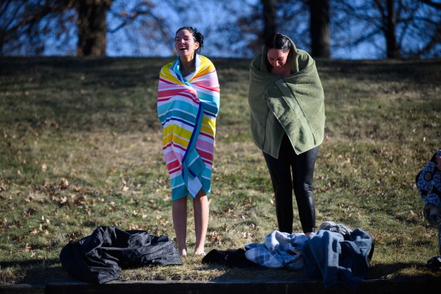 Polar plungers attempt to warm up after a cold dip in the lake at Burns Harbor's Lakeland Park on Saturday, Jan. 4, 2025. (Kyle Telechan/for the Post-Tribune)