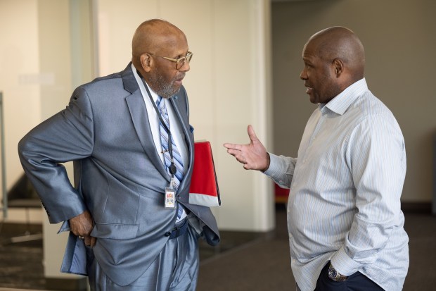 Earl H. Smith, Jr., on left, speaks with Gary Sports Hall of Fame inductee and former MLB outfielder Lloyd McClendon during an inaugural event for the Gary Sports Hall of Fame at the IUN Arts and Sciences building in Gary on Friday, July 29, 2022. (Kyle Telechan for the Post-Tribune)