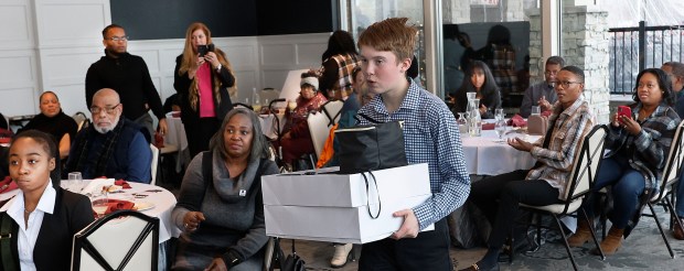 Alejandro Muniz, a student at Highland Middle School, carries items given out during a kick off event at the Innsbrook CC by the ECIER Foundation of Merrillville. Muniz is one of a dozen students that are going to Washington, D.C. to partake in tours and events prior to the inauguration.The students took part in the kick off on Saturday, Jan. 11, 2025. (John Smierciak / Post-Tribune)