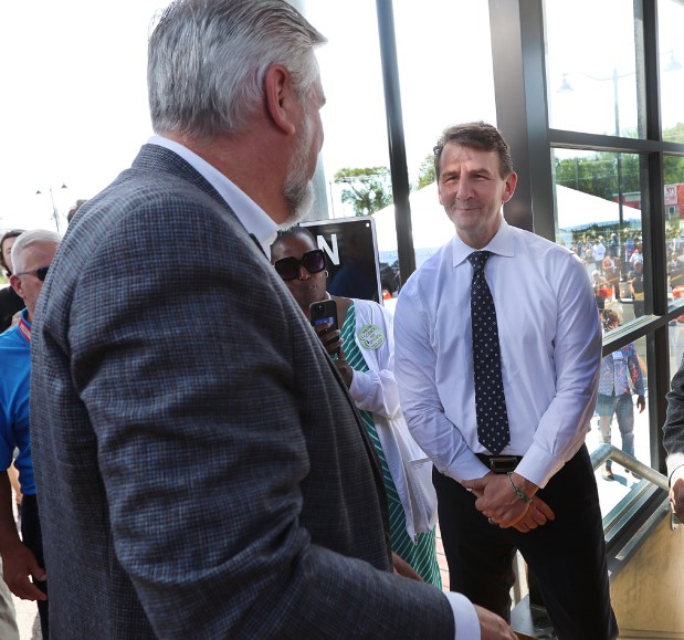 Indiana Governor Eric Holcomb (left) greets Congressman Frank Mrvan (right) as he arrives during a ribbon cutting ceremony at the Miller Station in Gary to commemorate the South Shore Line Double Track NWI Project on Monday, May 13, 2024. (John Smierciak/for the Post Tribune)