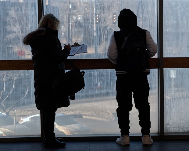 Volunteer Erin Sherron-Hayes (left) interviews a homeless young man (right) at the Gary Metro Station as volunteers launched their annual homeless count on Wednesday, Jan. 29, 2025. (John Smierciak / Post-Tribune)