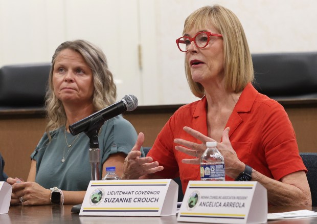 As Social Service Coordinator at Griffith Police Department Erica Rios (left) listens, Lt. Gov. Suzanne Crouch (right), relates her family has a member involved in mental health during a roundtable discussion on Northwest Indiana's mental health needs and resources available to the community hosted by State Rep. Mike Andrade (D-Munster). Participants were Crouch, Rios, President of Indiana Counseling Association, Angelica Arreola and Clinical Psychologist at Regional Mental Health, Dr. Brian Dieckmann. The roundtable took place at the Munster Town Hall on Wednesday, Aug. 28, 2024. (John Smierciak/Post Tribune)