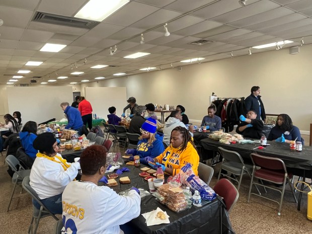 Volunteers help create care packages during Morning Bishop Theatre Playhouse's community service event in honor of Martin Luther King, Jr. Day. About 40 volunteers participated in Monday's event. (Maya Wilkins/Post-Tribune)