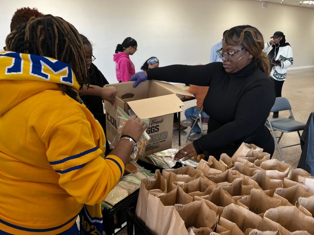 McKenya Dilworth-Smith, executive director of Morning Bishop Theatre Playhouse, prepares care packages during the organization's 18th annual Martin Luther King, Jr. Day event. Care packages included peanut butter and jelly sandwiches, first aid kits and socks. (Maya Wilkins/Post-Tribune)