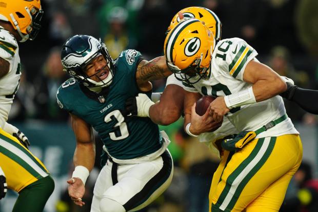 Green Bay Packers quarterback Jordan Love (10) is under pressure by Philadelphia Eagles linebacker Nolan Smith Jr. (3) during the first half of an NFL wild-card playoff football game Sunday, Jan. 12, 2025, in Philadelphia. (AP Photo/Derik Hamilton)