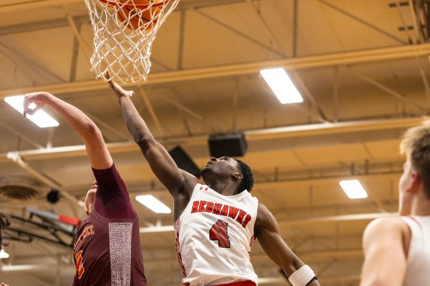 Marist's Karson Thomas (4) lays the ball up against Brother Rice during a nonconference game in Chicago on Tuesday, Jan. 21, 2025. (Vincent D. Johnson / for the Daily Southtown)