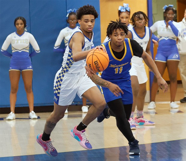 Bloom's Elijah Lovemore (left) and Crete-Monee's Robert Kennedy (11) chase down a loose ball during a basketball game in Chicago Heights on Tuesday, Jan. 7, 2025. (John Smierciak / Daily Southtown)