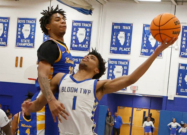 Bloom's Elijah Lovemore (1) drive into Crete-Monee's Robert Kennedy (11) on his way to the hoop during a basketball game in Chicago Heights on Tuesday, Jan. 7, 2025. (John Smierciak / Daily Southtown)