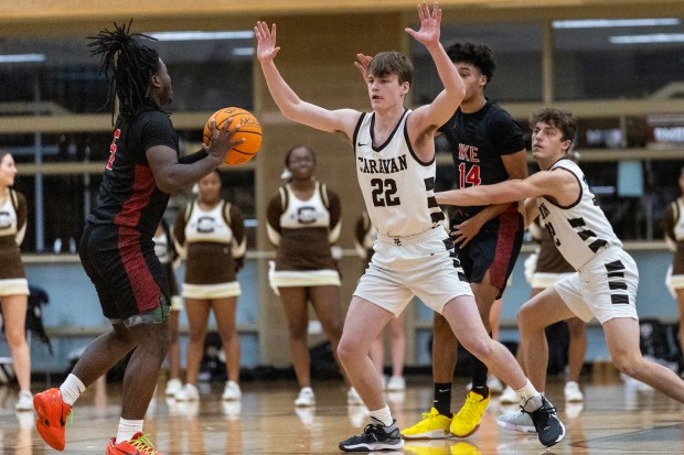 Mount Carmel's Eddie Ryan (22) defends as Eisenhower's Tae'jon Jackson (5) looks to pass during a nonconference game in Chicago on Monday, Jan. 6, 2025. (Vincent D. Johnson / for the Daily Southtown)