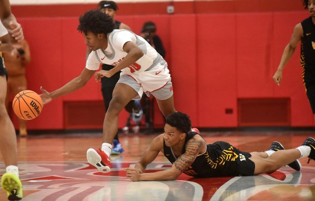 Homewood-Flossmoor's Ethan Howard (10) grabs the loose ball as Joliet West's Zion Gross (10) dives after it during the MLK "The Dream Continues" High School Invitational Monday, Jan. 20, 2025 in Flossmoor, IL. (Steve Johnston/for the Daily Southtown)