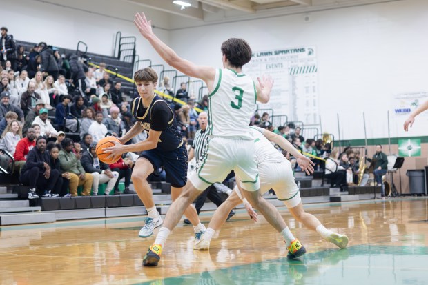 Lemont's Matas Gaidukevicius (20) drives to the basket against Oak Lawn during an SSC game in Oak Lawn on Friday, Jan. 10, 2025. (Troy Stolt / for the Daily Southtown)