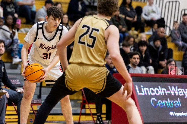 Lincoln-Way Central's Jack Rimkunas (31) looks for a passing option against Oak Forest during a nonconference game in New Lenox on Friday, Jan. 24, 2025. (Vincent D. Johnson / for the Daily Southtown)