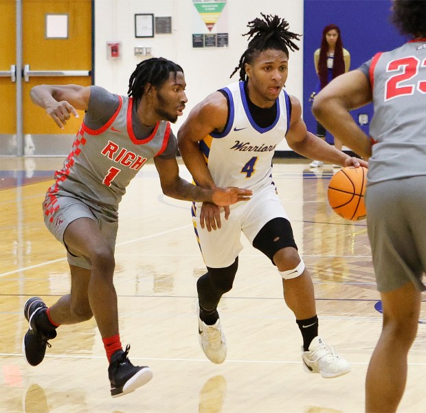 Rich Township's Ikee Brooks, left, guards Crete-Monee's Zyheir Gardner, center, during a basketball game in Crete on Friday, Jan..17, 2025 (John Smierciak / Daily Southtown)