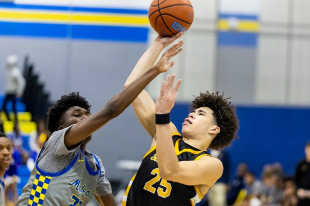 St. Laurence's Jacob Rice (25) finishes off a shot after being fouled by De La Salle's Caleb Henry (22) during a Catholic League crossover game in Chicago on Tuesday, Jan. 4, 2025. (Vincent D. Johnson / for the Daily Southtown)