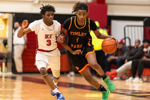 Tinley Park's Daniel Jervier (1) tries to get past Eisenhower's Michae Calvin (3) on his way to the basket during a South Suburban Conference game in Blue Island on Monday, Jan. 13, 2025. (Vincent D. Johnson / for the Daily Southtown)