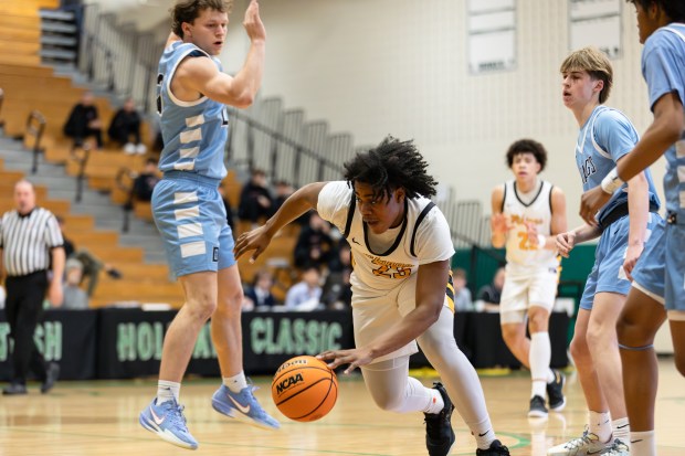 St. Laurence's Markese Peoples (23) drives to the basket against Downers Grove South during the Jack Tosh Holiday Classic third-place game in Elmhurst on Tuesday, Dec. 31, 2024. (Troy Stolt / for the Daily Southtown)