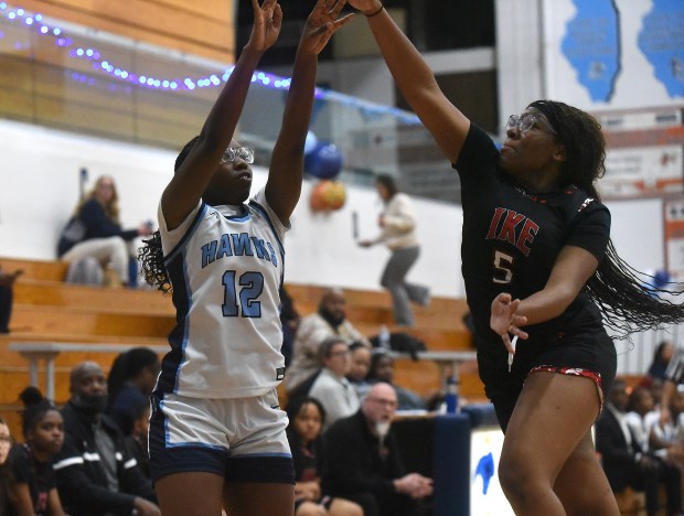 Hillcrest's Tia Rice (12) puts up a shot against Eisenhower's Tanijah White (5)during a South Suburban Conference game Thursday, Jan. 16, 2025 in Country Club Hills, IL. (Steve Johnston/for the Daily Southtown)