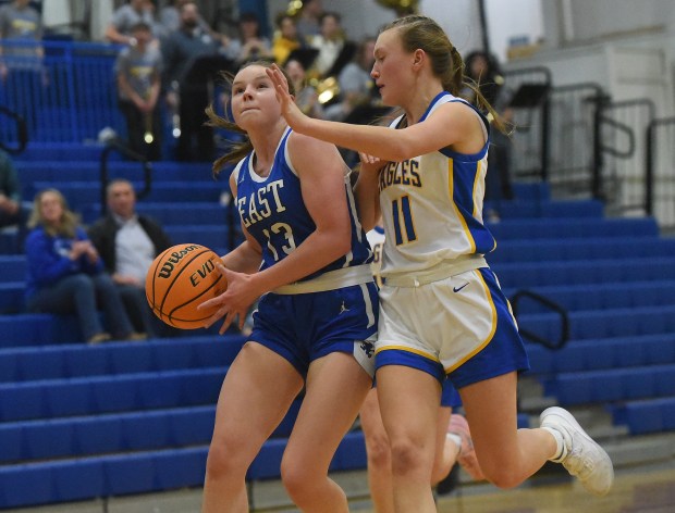 Lincoln-Way East's Madison Zaremba (13) tries to get a breakaway basket against Sandburg's Olivia Trunk (11) during a SouthWest Suburban Conference game Tuesday, Jan. 28, 2025 in Orland Park, IL. (Steve Johnston/for the Daily Southtown)