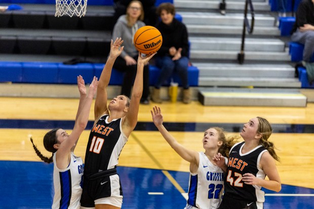 Lincoln-Way West's Molly Finn (10) makes s shot while getting fouled by Lincoln-Way East's Emmerson Nilsson (3) late in the fourth quarter during a Southwest Suburban Conference game in Frankfort on Tuesday, Jan. 7, 2025. (Vincent D. Johnson / for the Daily Southtown)