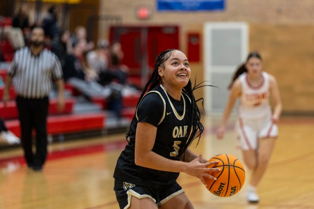 Oak Forest's Ambriel Anderson (3) joyously looks up at the basket before taking a wide open shot against Tinley Park during a South Suburban Blue game in Tinley Park on Thursday, Jan. 30, 2025. (Vincent D. Johnson / for the Daily Southtown)