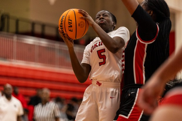 Homewood-Flossmoor's Jenesis Moore (5) goes up for a shot against Rich Township during the H-F MLK Shootout in Flossmoor on Saturday, Jan. 18, 2025. (Vincent D. Johnson / for the Daily Southtown)