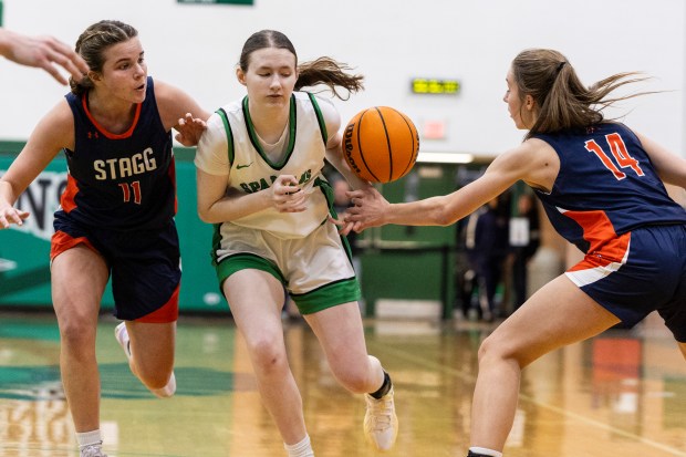 Stagg's Abbey Hobart (14) strips the ball from Oak Lawn's Olivia Perry (23) during a nonconference game in Oak Lawn on Saturday, Jan. 4, 2025. (Vincent D. Johnson / for the Daily Southtown)