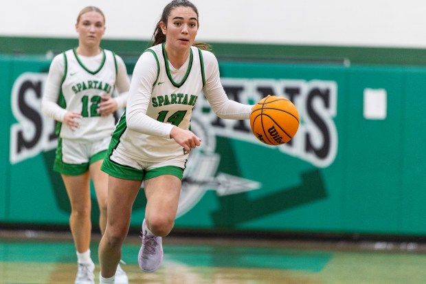 Oak Lawn's Danielle Dempsey (14) bring the ball up against Stagg during a nonconference game in Oak Lawn on Saturday, Jan. 4, 2025. (Vincent D. Johnson / for the Daily Southtown)