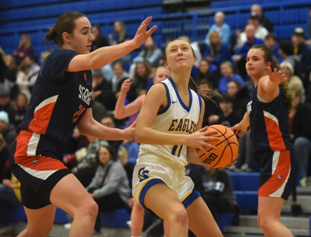 Stagg's Shannon Earley (21) defends Sandburg's Olivia Trunk (11) as she works to the basket during a SouthWest Suburban Conference game Tuesday, Jan. 21, 2025 in Orland Park, IL. (Steve Johnston/for the Daily Southtown)