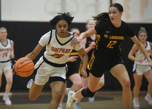 Shepard's Jessica Manley (20) tries to get up court past St. Laurence's Elle Rice (12) during a nonconference game Wednesday, Jan. 29, 2025 in Palos Heights, IL. (Steve Johnston/for the Daily Southtown)