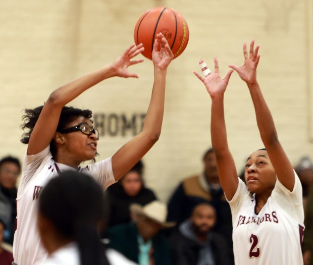 Morgan Park Academy's Morgan Williams and Anna Sheppard reach for the ball during the basketball game against Unity Christian in Chicago on Wednesday, Jan. 15, 2025. (James C. Svehla / for the Daily Southtown)