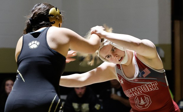 Lockport's Sophie Kelner (right) gets a hair pulled by Oak Forest's Isabell Peralta (left) during a wrestling match at Oak Forest High School on Wednesday Jan. 15, 2025 (John Smierciak / Daily Southtown)