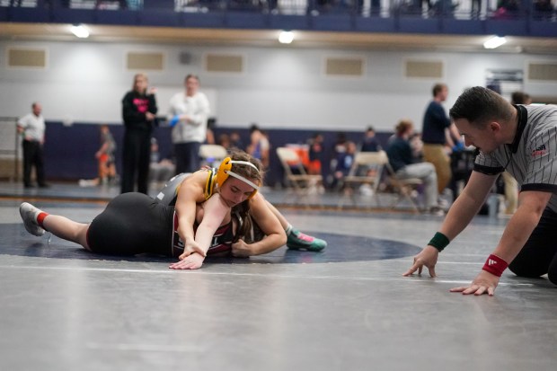 Metea Valley's Ashley Basmajian attempts a pin of Plainfield North's Meryn Finnegan during their 115 pound championship bout in the Aaron Dudley Memorial Girls Wrestling Invite at Oswego East High School on Saturday, Jan. 4, 2025. (Sean King / for The Daily Southtown)