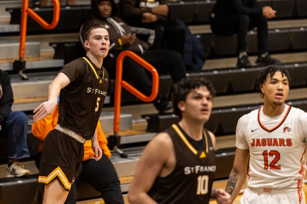 University of St. Francis' Nick Diego (5) watches as his shot falls in for three against Governors State University during a Chicagoland Collegiate Athletic Conference game in University Park on Wednesday, Jan. 8, 2025. (Vincent D. Johnson / for the Daily Southtown)