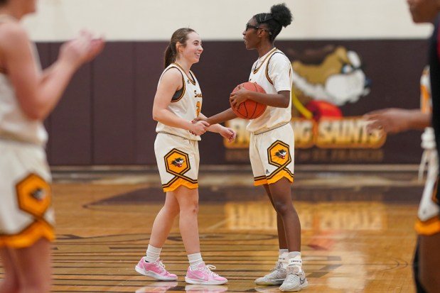 St. Francis' Laurelei Thormeyer (left) and Tykara Harrison (right) shake hands after defeating St. Xavier at the conclusion of a woman's college basketball game at University of St. Francis in Joliet on Wednesday, Jan. 15, 2025. (Sean King / for The Daily Southtown)