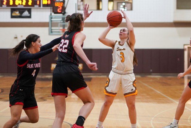 St. Francis' Laurelei Thormeyer (3) shoots the ball against St. Xavier's Maeve Egan (4) and Eleanor Harris (22) during a woman's college basketball game at University of St. Francis in Joliet on Wednesday, Jan. 15, 2025. (Sean King / for The Daily Southtown)