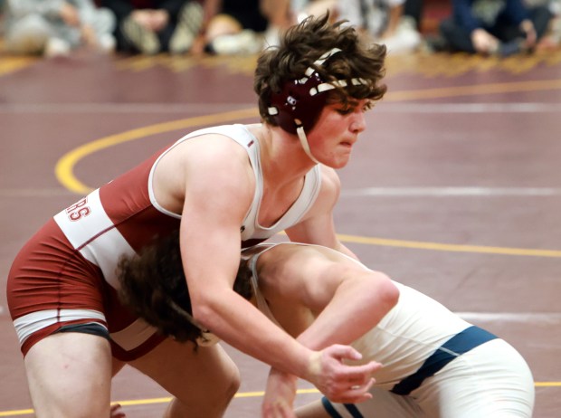 (175) Dan Costello of Brother Rice, top, and Brody Kelly of Elmhurst (IC Catholic), bottom, during the 2025 Chicago Catholic League Championship wrestling tournament held at Montini Catholic High School in Lombard on Saturday, Jan. 25, 2025. (James C. Svehla / for the Daily Southtown)