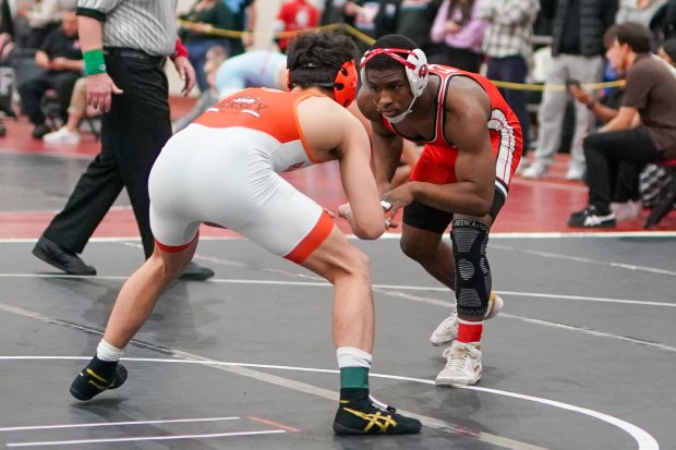 Marist's Donavon Allen (right) and Hersey's Maksim Mukhamedaliyev circle the mat during their 144 pound championship bout in the Illini Classic Wrestling Classic at Lincoln-Way Central High School in New Lenox on Saturday, Jan. 18, 2025. (Sean King / for The Daily Southtown)