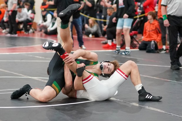 Providence Catholic's Justus Heeg attempts an early pin against Yorkville's Donovan Rosauer during their 150 pound championship bout in the Illini Classic Wrestling Classic at Lincoln-Way Central High School in New Lenox on Saturday, Jan. 18, 2025. (Sean King / for The Daily Southtown)