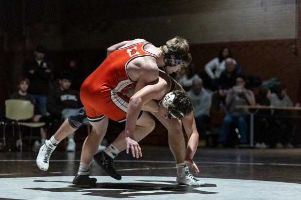 Marist's Ricky Ericksen III, left, tries to get Mount Carmel's Kenneth Seggerson to the mat in the 190-pound match during a nonconference meet in Chicago on Friday, Jan. 10, 2025. (Vincent D. Johnson / for the Daily Southtown)