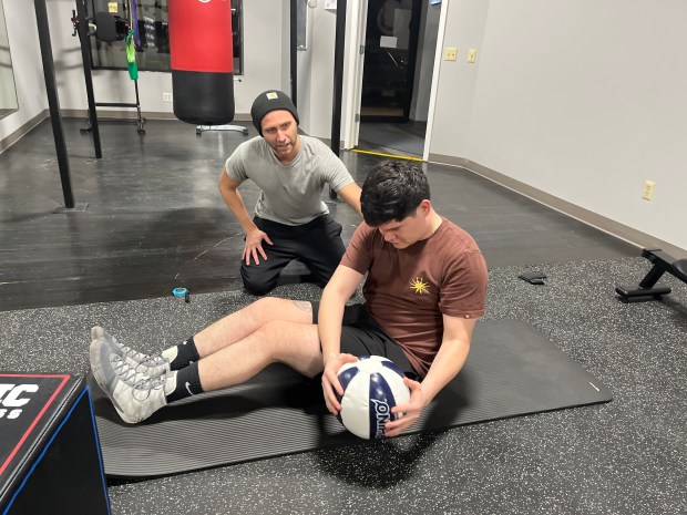 Frankfort resident Mario Ferreira trains with John Sommer, a longtime friend of BVL Boxing Solutions owner Joe Leonard. Sommer leads workouts at the newly opened boxing gym. (Samantha Moilanen/Daily Southtown)