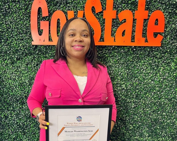 Meagan Sims, of Richton Park holds a Women Who Advocate for Equity, Diversity, and Inclusion plaque she received for her activities at Governors State University. (Meagan Sims)