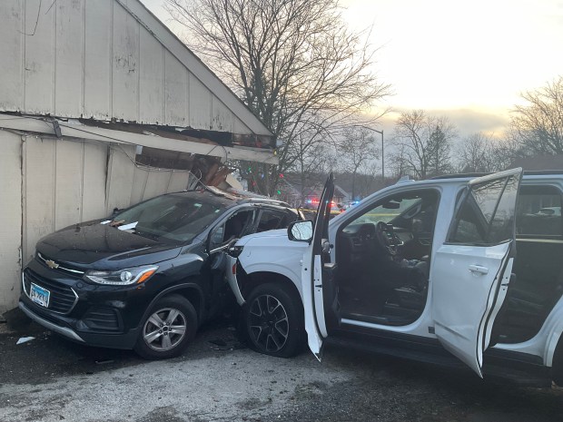 A car crashed into Julia Baker's home at 46 Apache St., in Park Forest Dec. 30, 2024, striking her black Chevrolet and damaging the living room. The house has since been declared uninhabitable until repairs can be made. (Julia Baker)