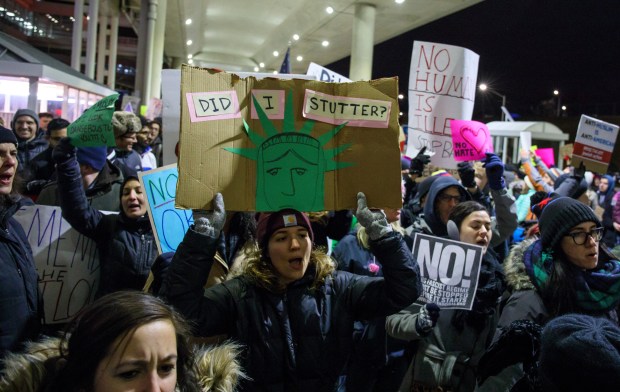 Demonstrators converge in reaction to the executive order travel ban , called the 'Muslim ban', outside Terminal 5 of O'Hare International Airport onJan. 29, 2017. (Brian Cassella/Chicago Tribune)