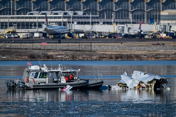 A crash site involving an American Airlines flight and a U.S. Army helicopter in the Potomac River near Ronald Reagan Washington National Airport, seen from Joint Base Anacostia-Bolling in Washington, on Jan. 30, 2025. An American Airlines jet carrying 64 people plunged into the Potomac River after colliding in midair with an Army helicopter on Wednesday night. (Kenny Holston/The New York Times)