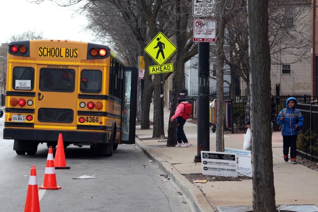 A school bus sits outside Funston Elementary School on W. Armitage Avenue at dismissal time on on March 21, 2024. (Terrence Antonio James/Chicago Tribune)