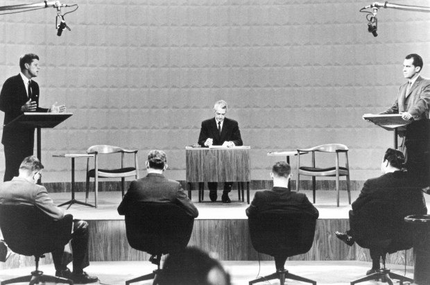 Massachusetts Sen. John F. Kennedy, left, debates Vice President Richard M. Nixon, right, with debate moderator Howard K. Smith in the middle at Studio One at WBBM-TV in Chicago on Sept. 26, 1960. This was the first ever televised presidential debate. In the foreground are the backs of the journalist panel that posed the questions to the candidates. (AP)