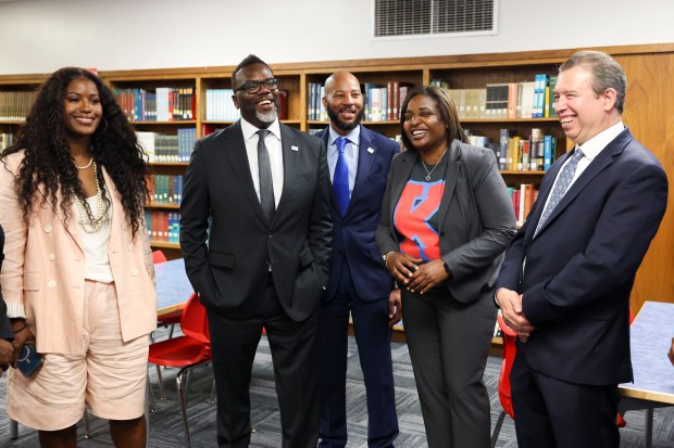 CTU President Stacy Davis Gates, from left, Mayor Brandon Johnson, Alderman Lamont J. Robinson, 4th, Principal Karen Calloway, and CPS CEO Pedro Martinez chat in the library on the first day of school at Kenwood Academy High School in the Kenwood neighborhood on Aug. 21, 2023. (Eileen T. Meslar/Chicago Tribune)