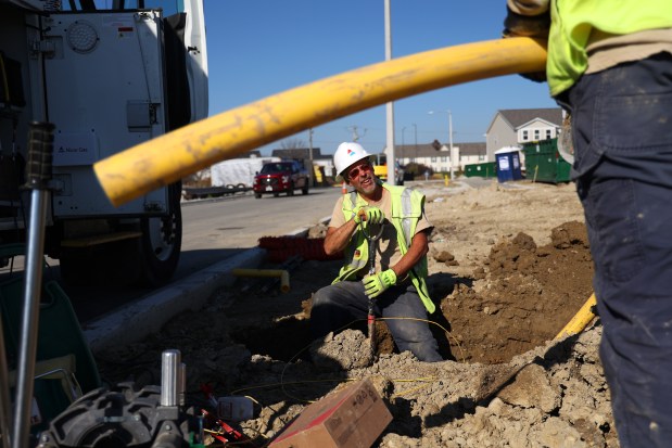 Nicor Gas workers dig a trench for a gas line in 2022, in Aurora. (Stacey Wescott/Chicago Tribune)