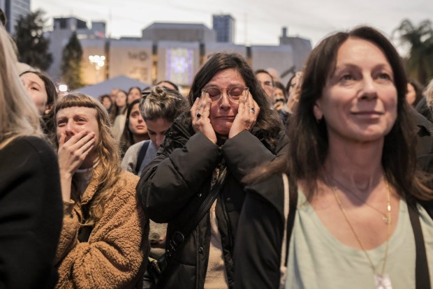 People gathering at the Hostages Square in Tel Aviv, Israel, react to the news that the first hostages have been released after a ceasefire agreement began between Israel and Hamas, on Jan. 19, 2025. (Avishag Shaar-Yashuv/The New York Times)